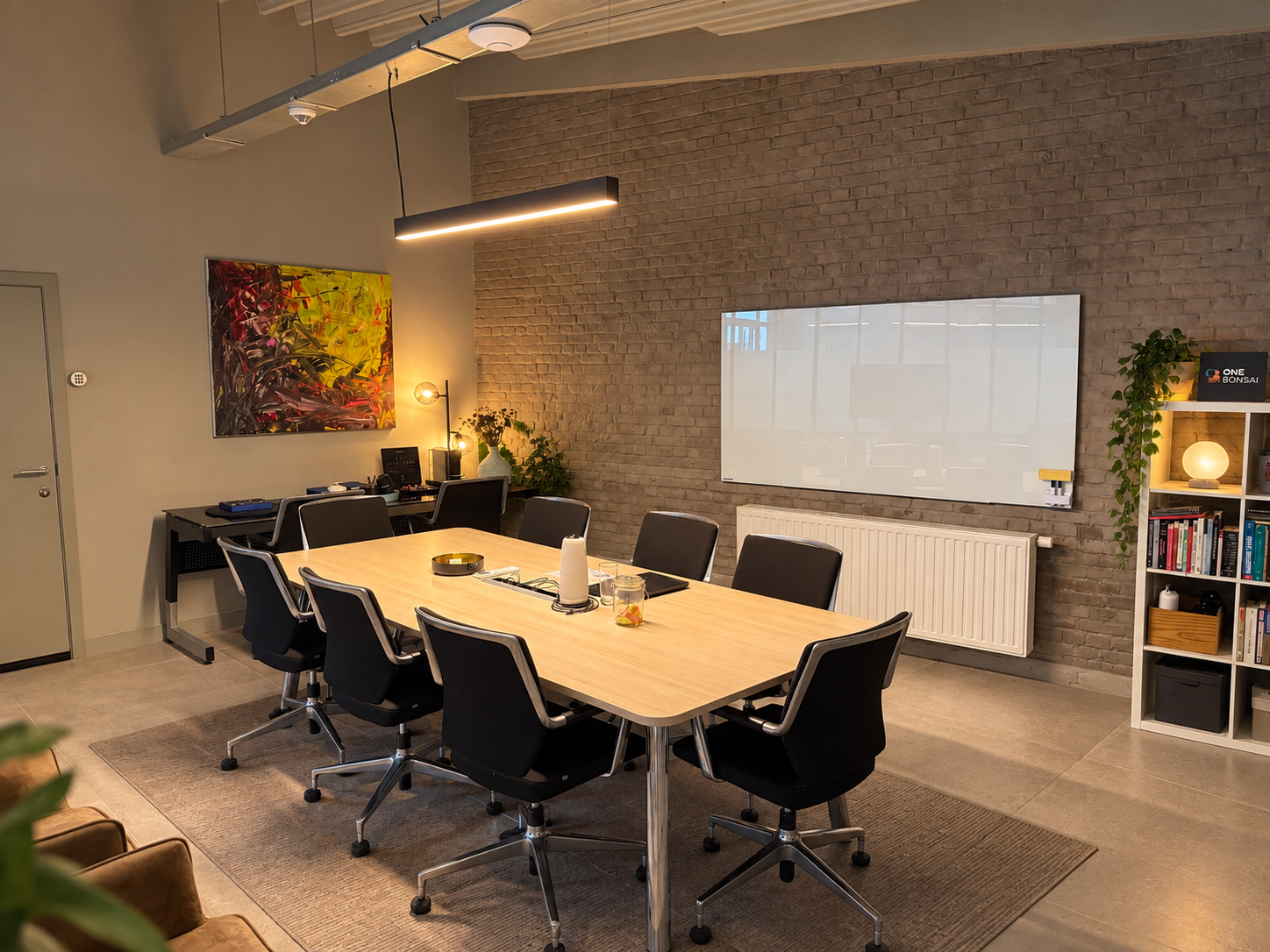 Large meeting room with a table for eight and a whiteboard