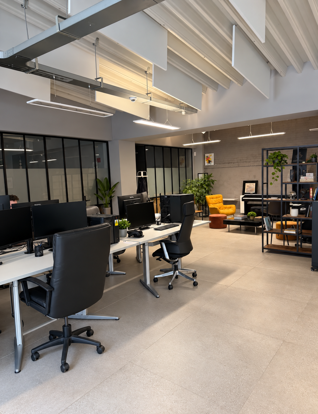 Shared open-plan office with desks and a lounge corner